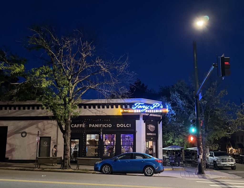tony p's italian restaurant iconic storefront in lohi denver on a hot summer night with a full moon in the background and a quiet street in front.